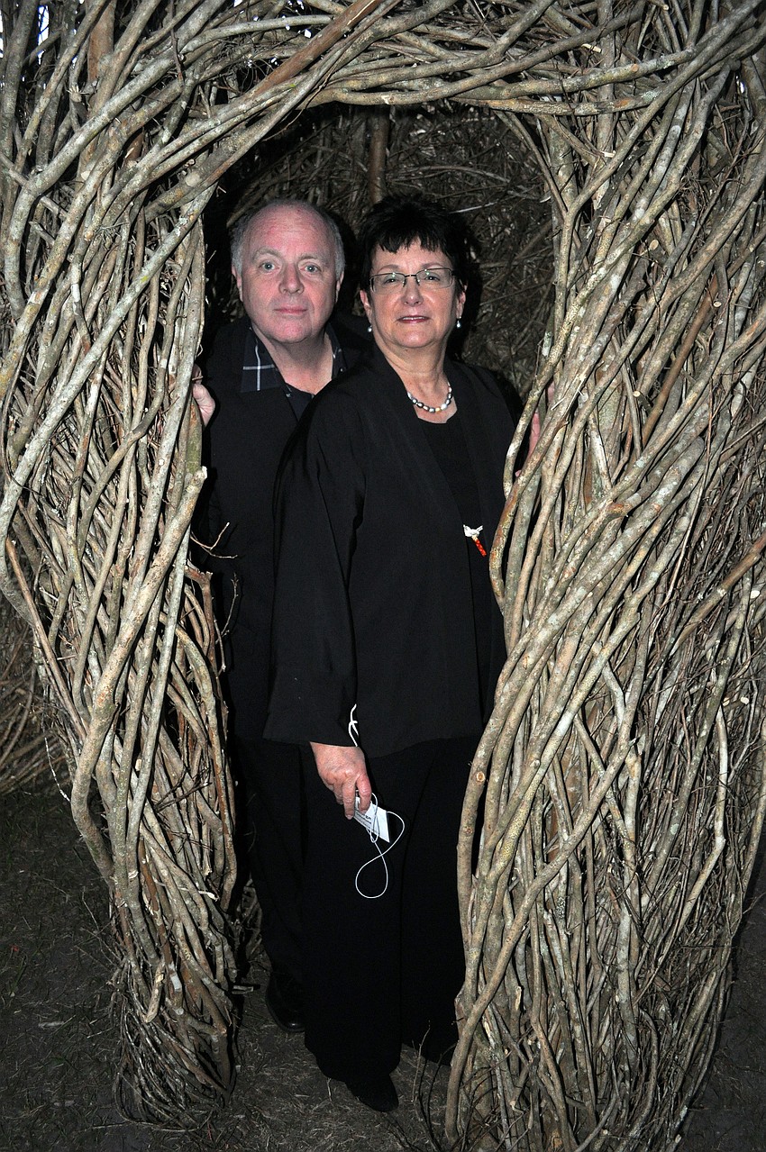 George Schofield and Linda DeMello found a place to hide inside the stick sculpture.