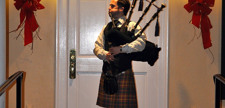 Ross Allen plays the bagpipe as guests arrived.
