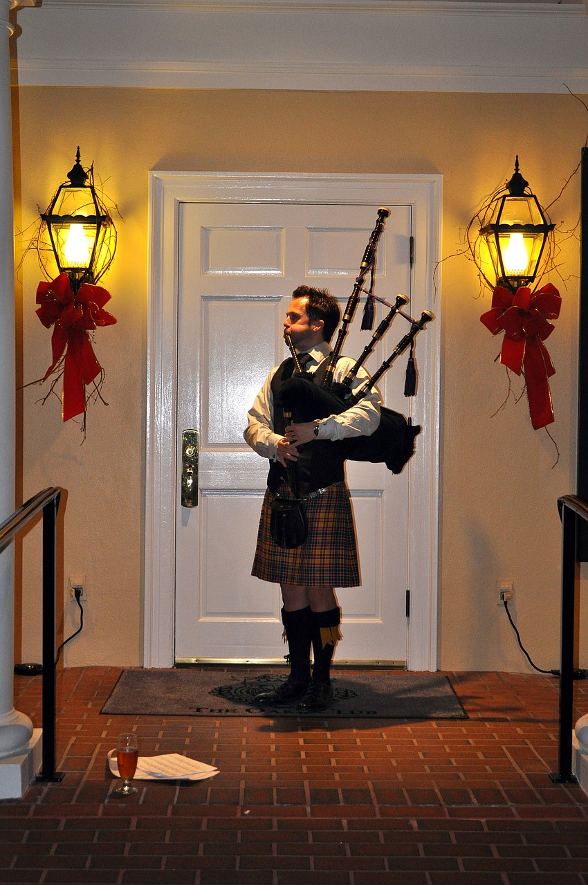 Ross Allen plays the bagpipe as guests arrived.