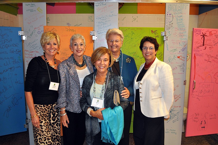 Teresa Simmons, Jill Colton, Rifka Glatz, Susan Coyne and Holly Ross pose in the colorful and artistic bathroom inside the Historic Sarasota High School.