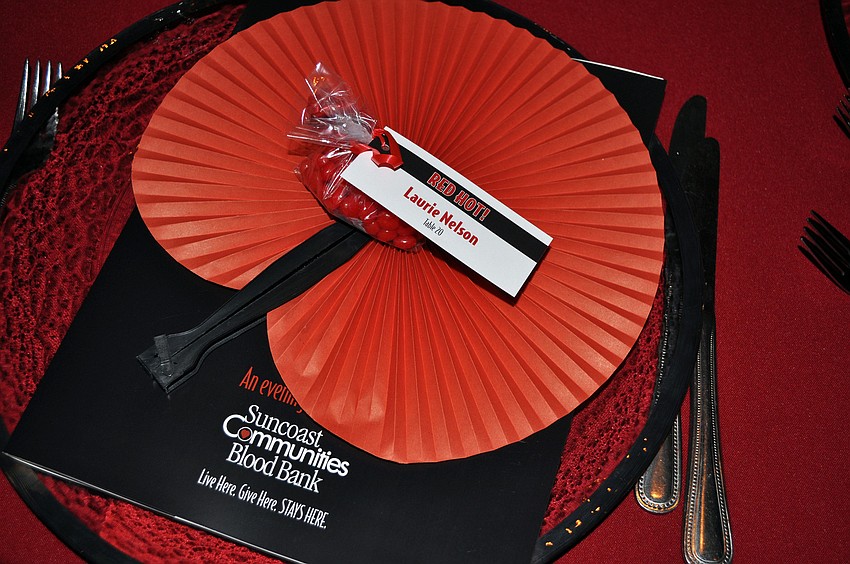 Each place setting had a program and a red fan.