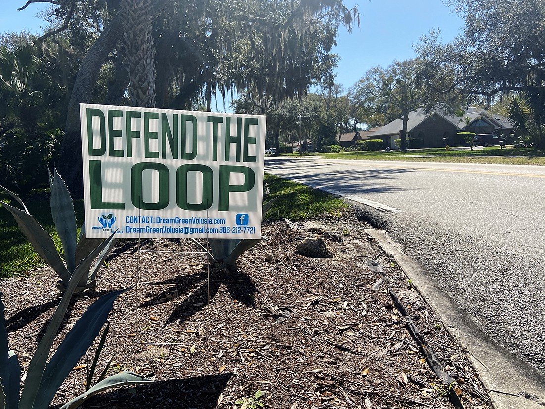 A 'Defend the Loop' sign on a home on Beach Street greets those coming in and out of the Loop. Photo by Jarleene Almenas