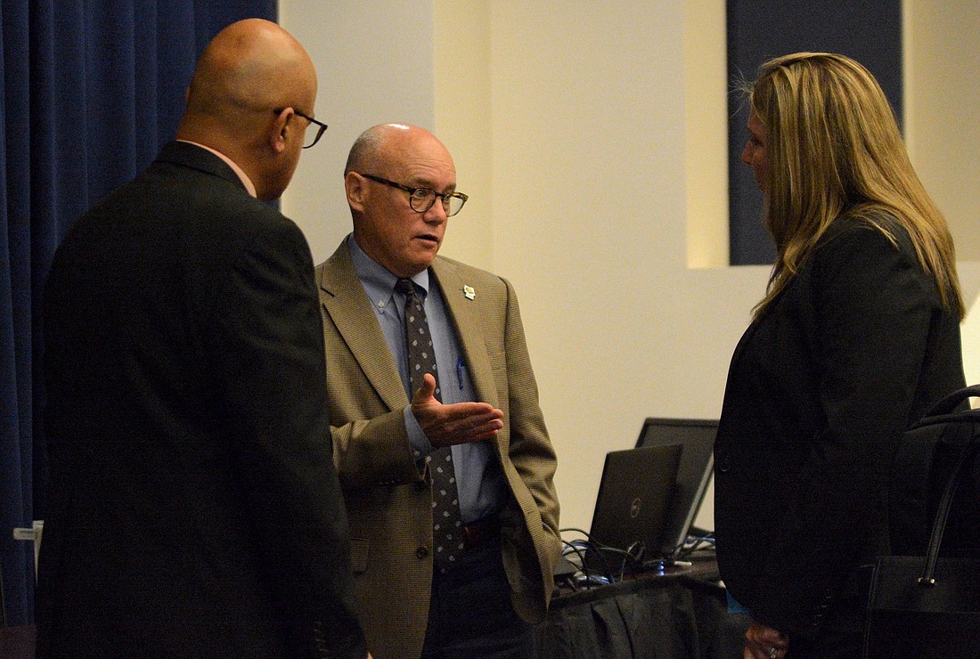 County Commission Chairman Donald O'Brien speaks with County Administrator Heidi Petito after an. Oct. 18 commission meeting. Photo by Jonathan Simmons