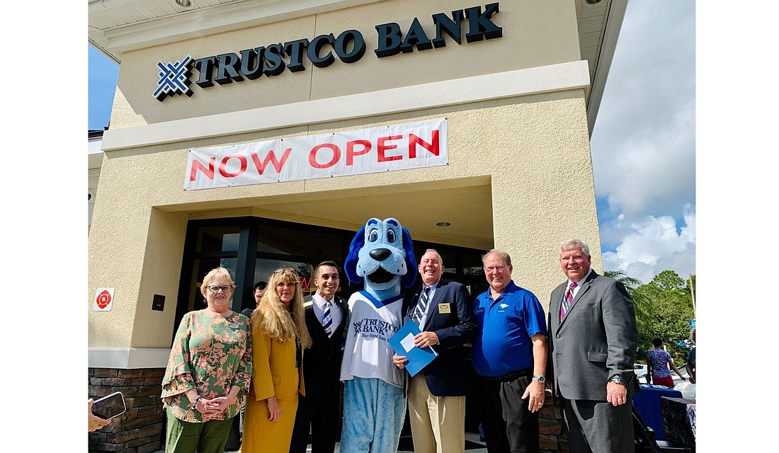 Sherri Crisman, Cynthia Smith, Vincent Amore, Mayor David Alfin, County Commissioner Greg Hansen and Eric Schreck at the opening of TrustCo Bank Palm Coast branch. Courtesy photo