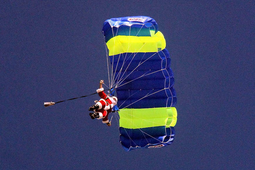 Santa parachutes into the 2014 parade. Photo by Shanna Fortier