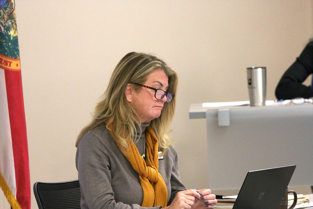 Colleen Conklin looks at staff presentation materials at the Dec. 7 School Board workshop. Photo by Brent Woronoff