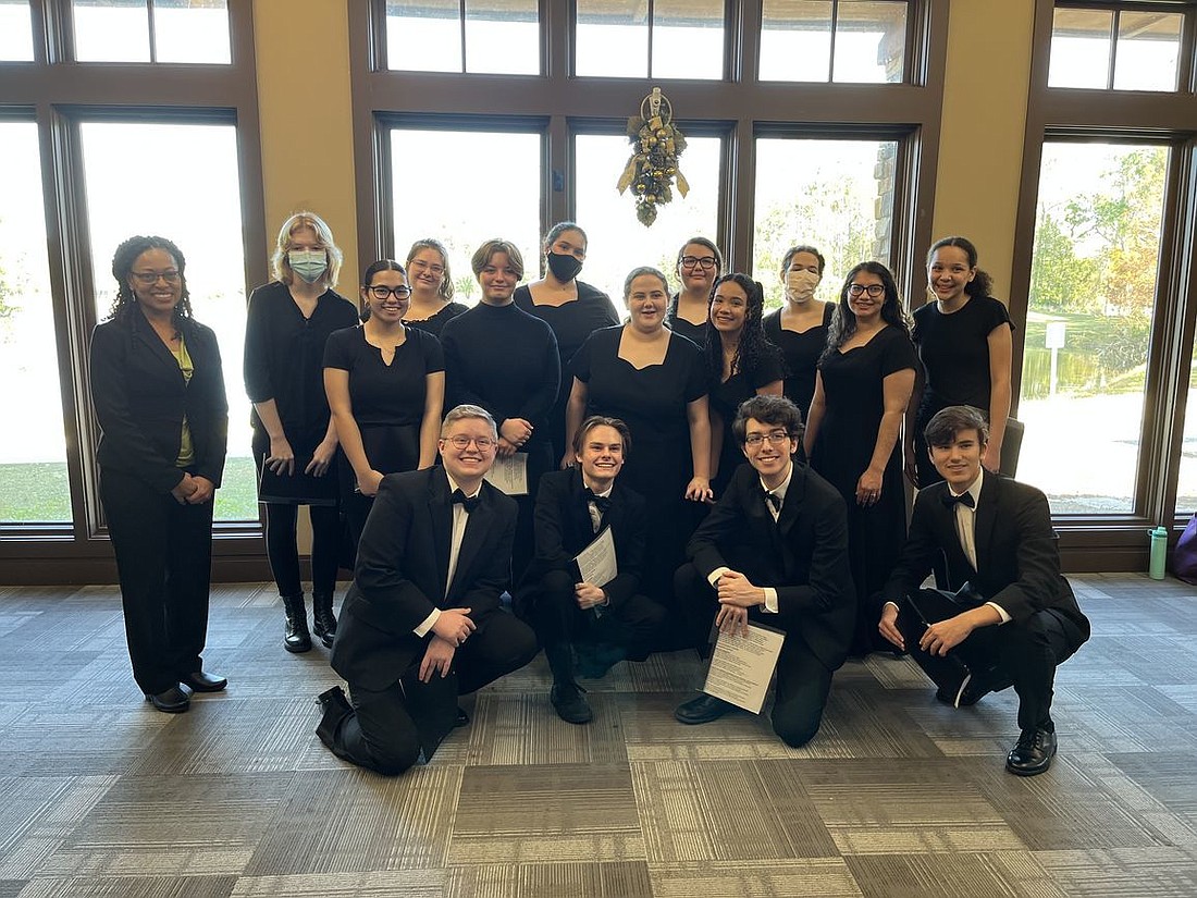 Choral Director Ester Jackson (left) and the Flagler Palm Coast High School Formality Singers perform for AAUW Flagler at Holiday Luncheon Meeting. Courtesy photo