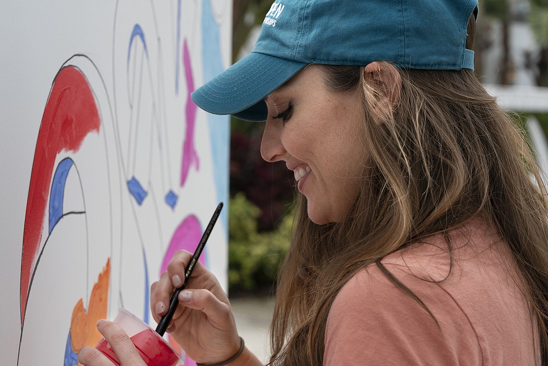 Becky Parker, of Ormond Beach MainStreet adds her personal touch to the art wall at the seventh-annual Granada Grand Festival of the Arts in 2021. File photo by Michele Meyers
