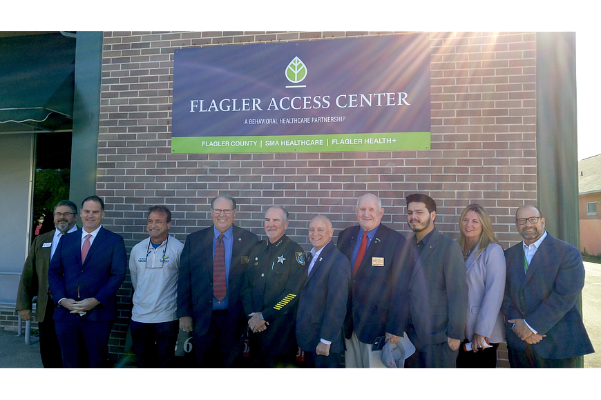 Local officials at a ribbon cutting for the Flagler Access Center. File photo by Brent Woronoff