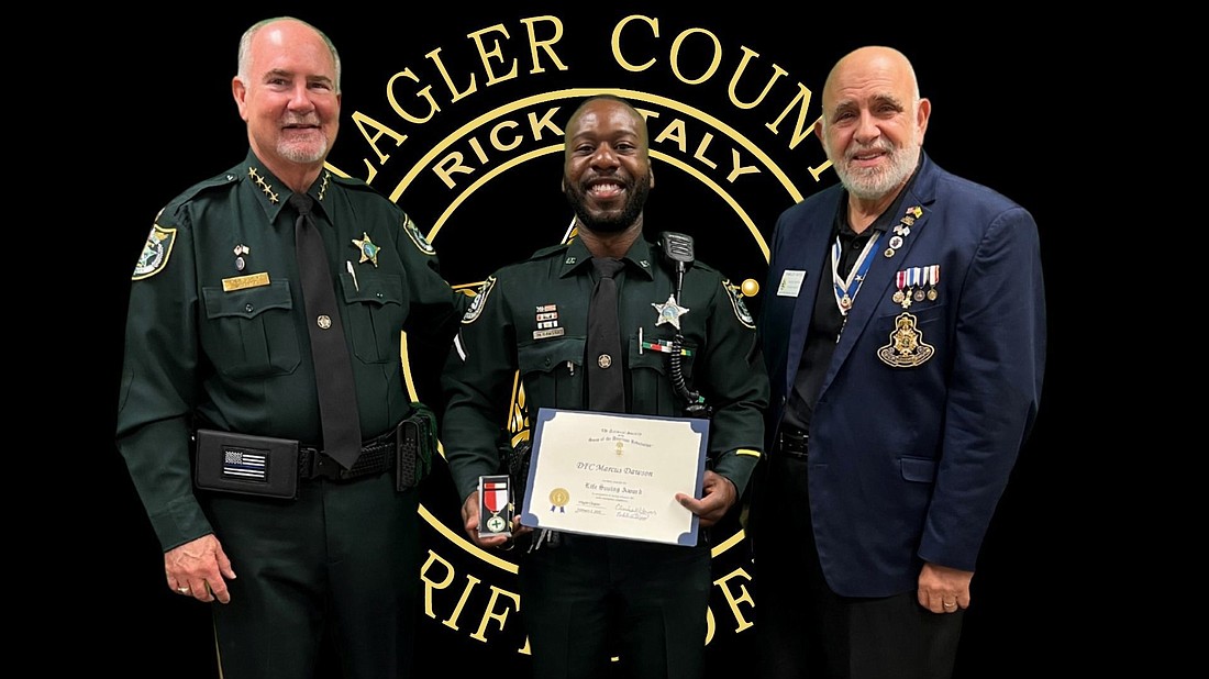 Flagler County Sheriff Rick Staly, DFC Marcus Dawson, Flagler County Chapter of the Sons of the American Revolution President Charles Hayes. Courtesy photo
