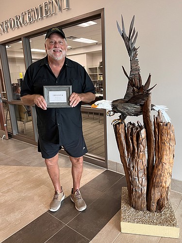 Artist Ron Wallace with public art piece at city hall. Courtesy photo