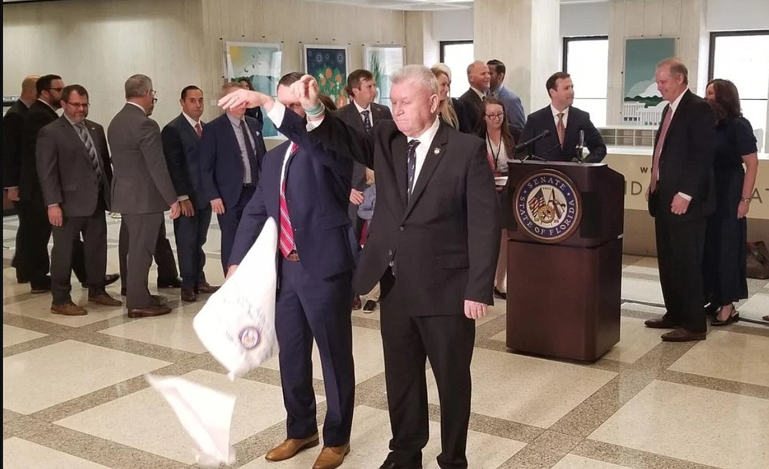 A traditional hanky drop ended the 2022 regular legislative session.  Photo by Jim Turner