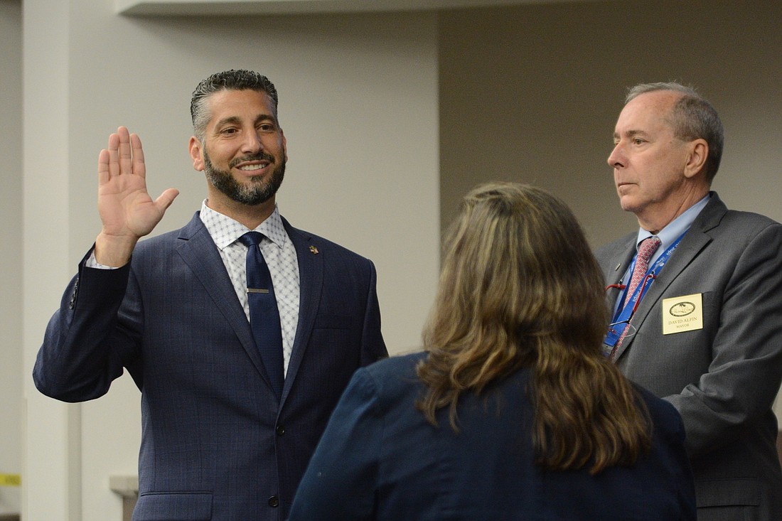 John Fanelli takes the oath of office at a City Council meeting on March 22. Photo by Jonathan Simmons