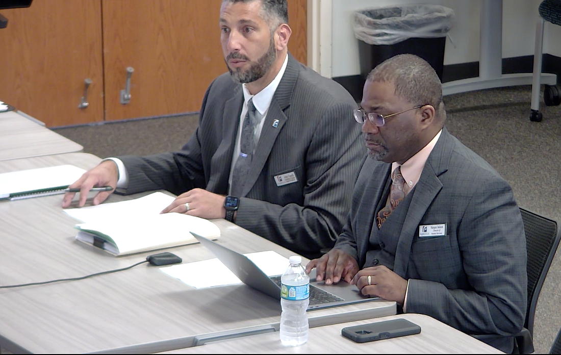 John Fanelli, coordinator of student supports and behavior, and Marquez Jackson, student services director, present dress code recommendations at a School Board workshop. Screen shot from Flagler Schools live stream