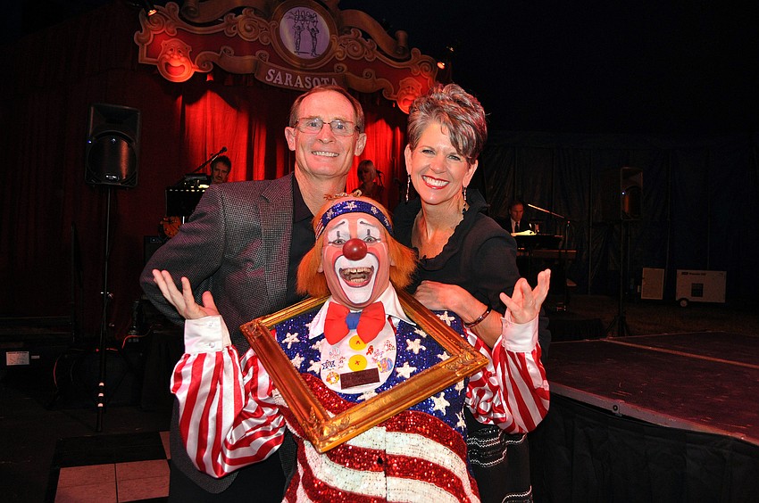 Chuck Sidlow jumps in front of Bradd and Sally Schule