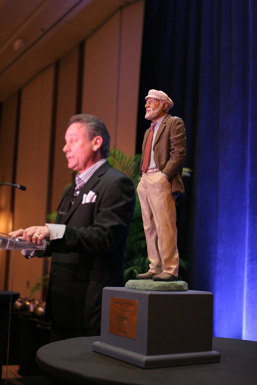 Chris Waters speaks to the crowd after the unveiling of the Lifetime Visionary Award.