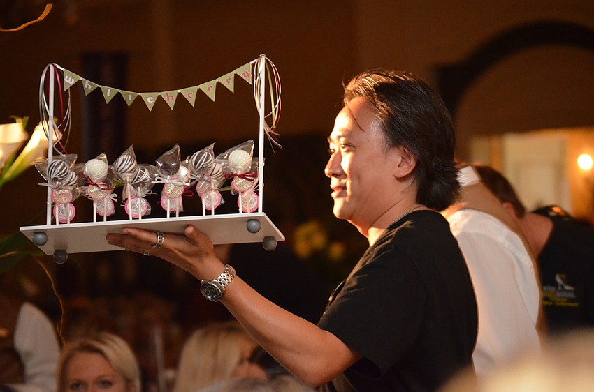 Tom Doan hands out lollicakes to guests.