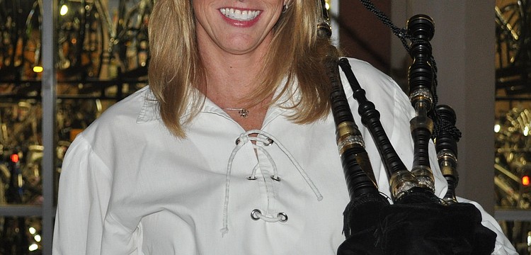 Anne Miller held her bagpipe.