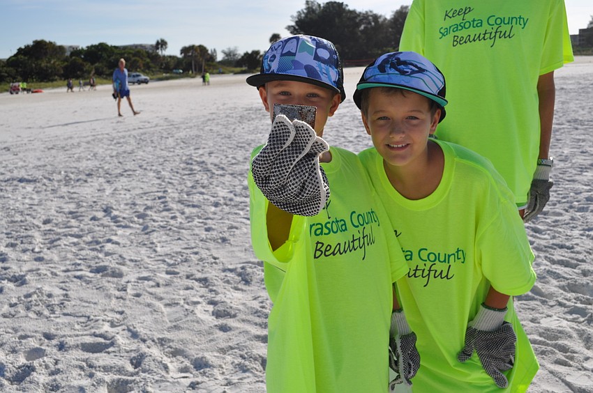 Dylan Colby, 8, and his brother Clay, 10, found a chunk of metal during the 2012 International Coastal Cleanup on Siesta Key beach, which began at 8 a.m. today.
