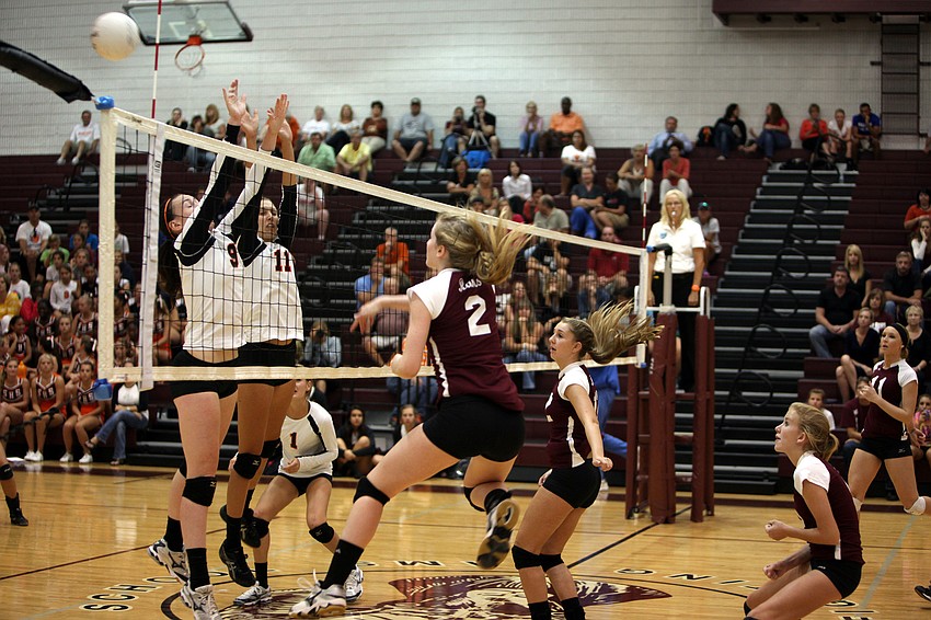 Emily Harding, No. 9, and Jacky Mogensen, No. 11, attempt to block Jen Moorâ€™s, No. 2, spike over the net during the first of three games played Monday, Sept. 17 at Riverview High Schoolâ€™s Gymnasium.