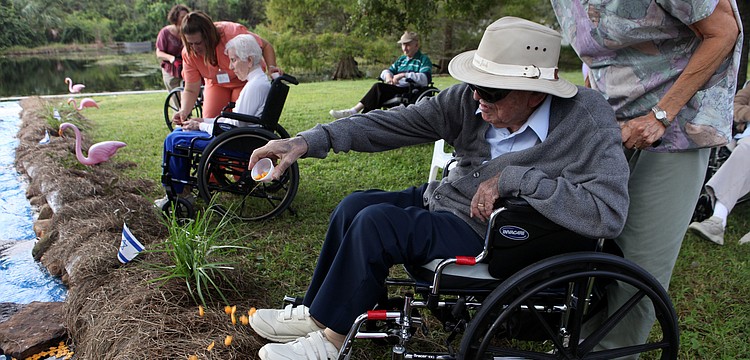 Ted Bleecker throws his cup of crackers into the replica River Jordan during the Tashlich ceremony. Bleecker noted that the replica â€œRiver Jordanâ€ and the ceremony was â€œremarkableâ€.