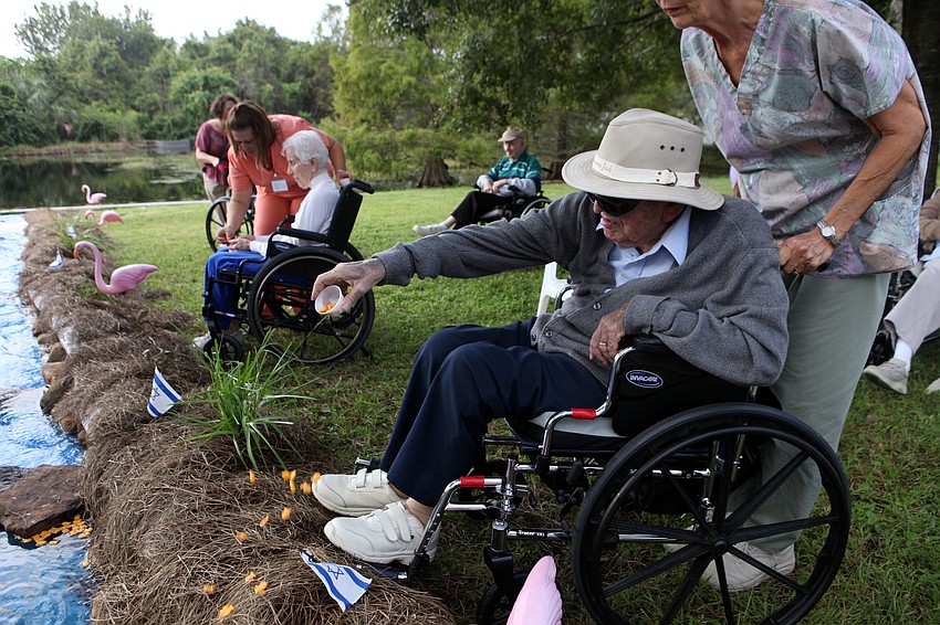 Ted Bleecker throws his cup of crackers into the replica River Jordan during the Tashlich ceremony. Bleecker noted that the replica â€œRiver Jordanâ€ and the ceremony was â€œremarkableâ€.