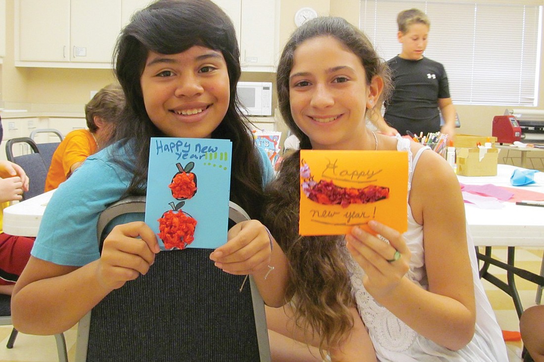 Mari Blumenthal and Lila Marlowe show off their New Year's cards. Courtesy photo.