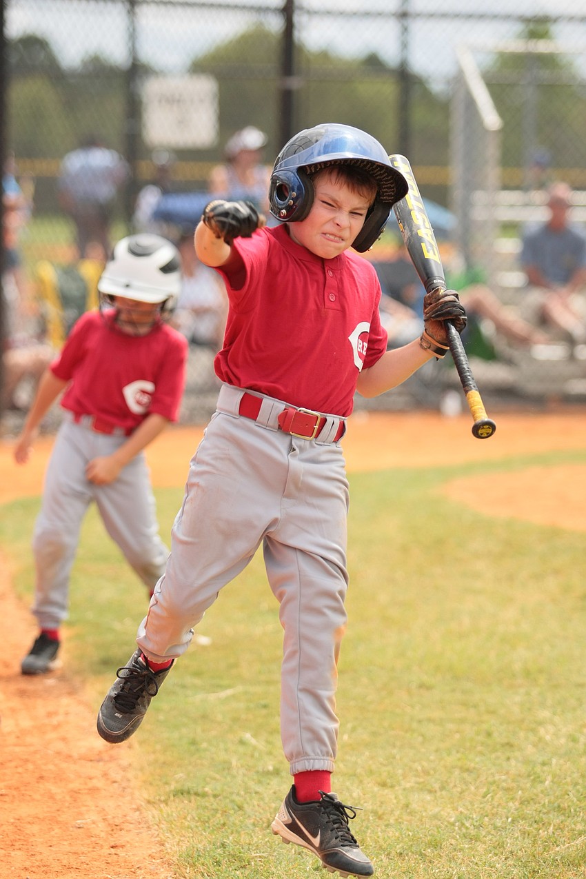 Jordan Shields celebrates after scoring a run for the Reds Minors team. Photos courtesy of Julie McCray.