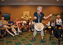 Jana Broder of Drum Magic leads the group in a pattern of drumming, snapping, clapping and tapping of the feet.
