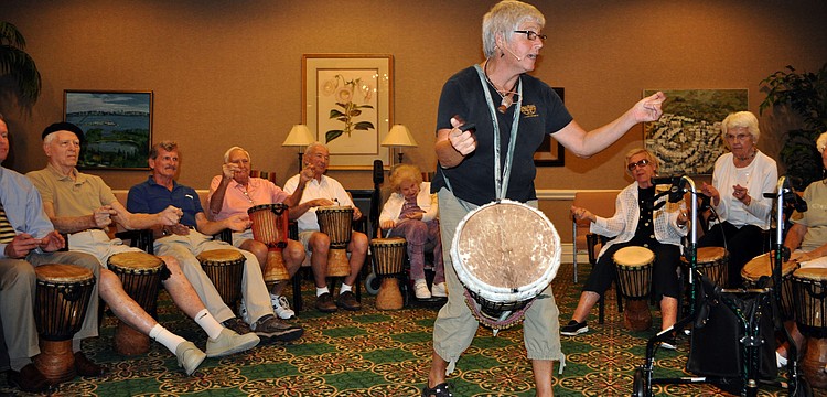 Jana Broder of Drum Magic leads the group in a pattern of drumming, snapping, clapping and tapping of the feet.