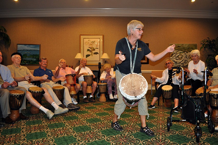 Jana Broder of Drum Magic leads the group in a pattern of drumming, snapping, clapping and tapping of the feet.