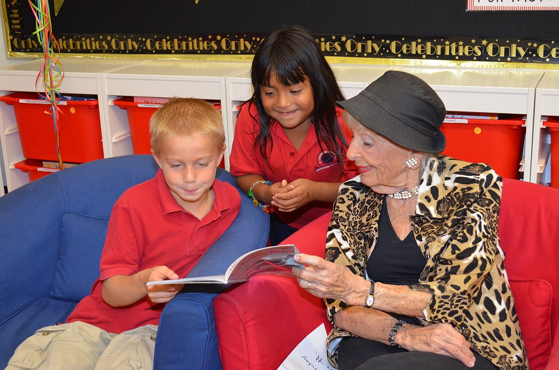 Southside Elementary students Alex Brantingham and Jazmin Light read with volunteer Henrietta Daytz.