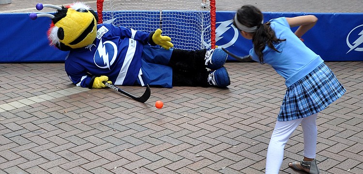 ThunderBug blocks the goal with his body as Stephanie Quintano, 8, tries to score Saturday, Sept. 29 during the Tampa Bay Lightningâ€™s Rolling Thunder Tour Sarasota stop at Five Points Park.
