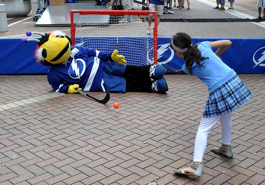 ThunderBug blocks the goal with his body as Stephanie Quintano, 8, tries to score Saturday, Sept. 29 during the Tampa Bay Lightningâ€™s Rolling Thunder Tour Sarasota stop at Five Points Park.