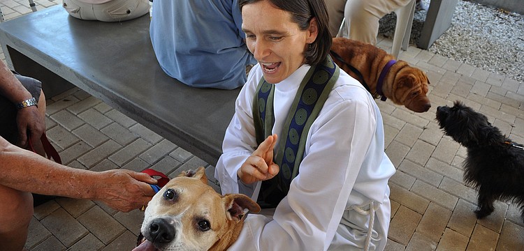 Associate Rector Andi Taylor blesses Gingerale, 11, at the Animal Blessing Sunday, Sept. 30 at St. Boniface Episcopal Church.