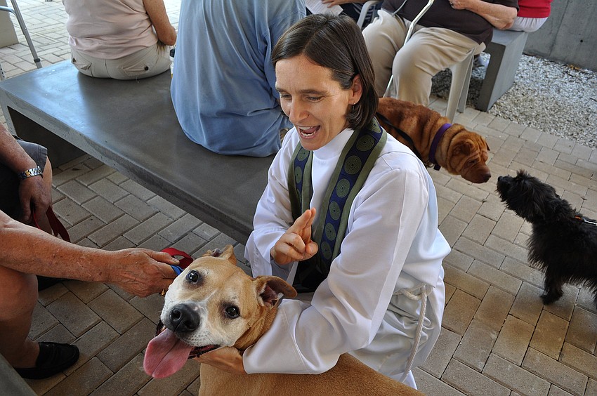 Associate Rector Andi Taylor blesses Gingerale, 11, at the Animal Blessing Sunday, Sept. 30 at St. Boniface Episcopal Church.