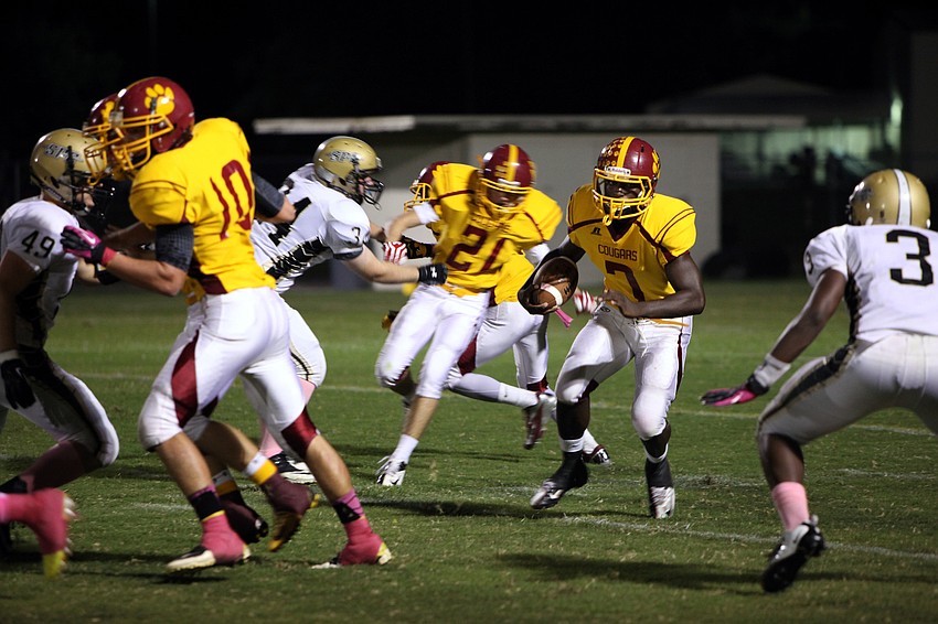 Demardre Patterson, No. 7, makes his way through the players and down the field Friday, Oct. 12, during Cardinal Mooneyâ€™s homecoming game against St. Petersburg Catholic.