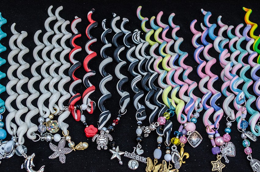 Hair Fancys are made out of clay and look like hair wraps. They come in various sizes, colors and have charms at the bottom.