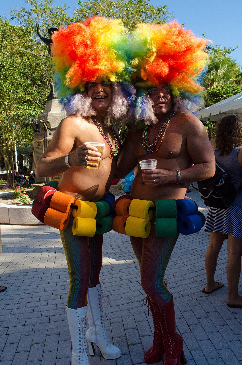 People dressed up in costume making the atmosphere fun and festive.
