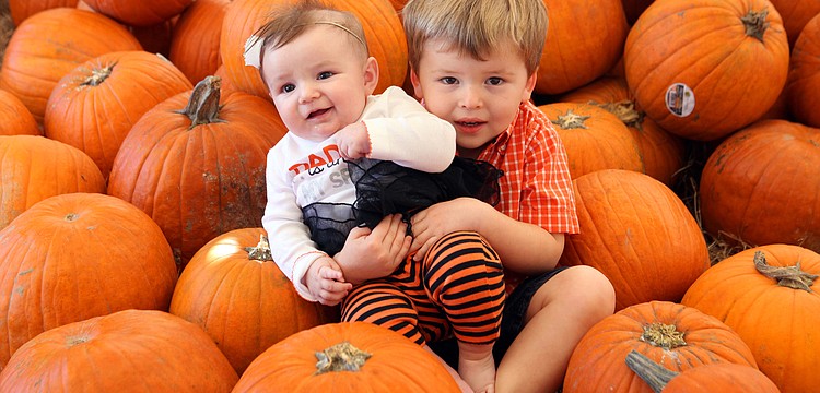 Gia, 4 mos., and Will Nielubowicz, 2, pose together for a photo in the pumpkin patch Saturday, Oct. 20, at the Fruitville Grove Pumpkin Festival.