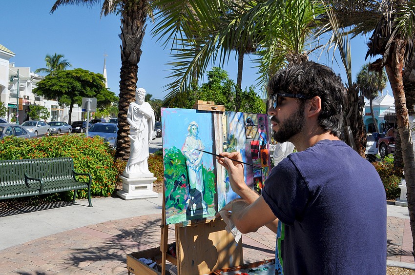 Andrew Theophilopoulos works on a painting.