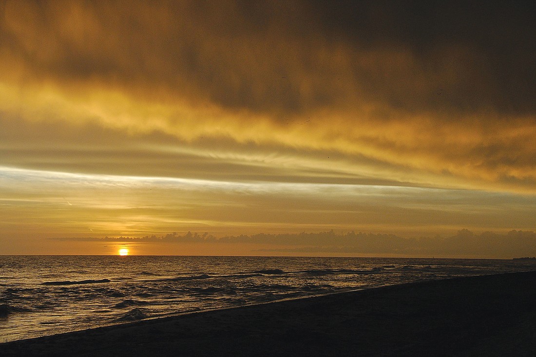 Lewis White took this sunset photo on Longboat Key as a rain shower moved on shore.