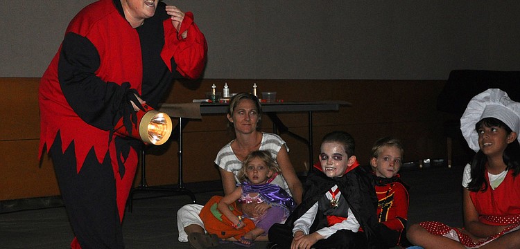 Marilyn Nykiforuk, assistant manager at Selby Public Library, tells a not so scary, scary story Wednesday, Oct. 24, at Selby Public Libraryâ€™s Halloween Party.