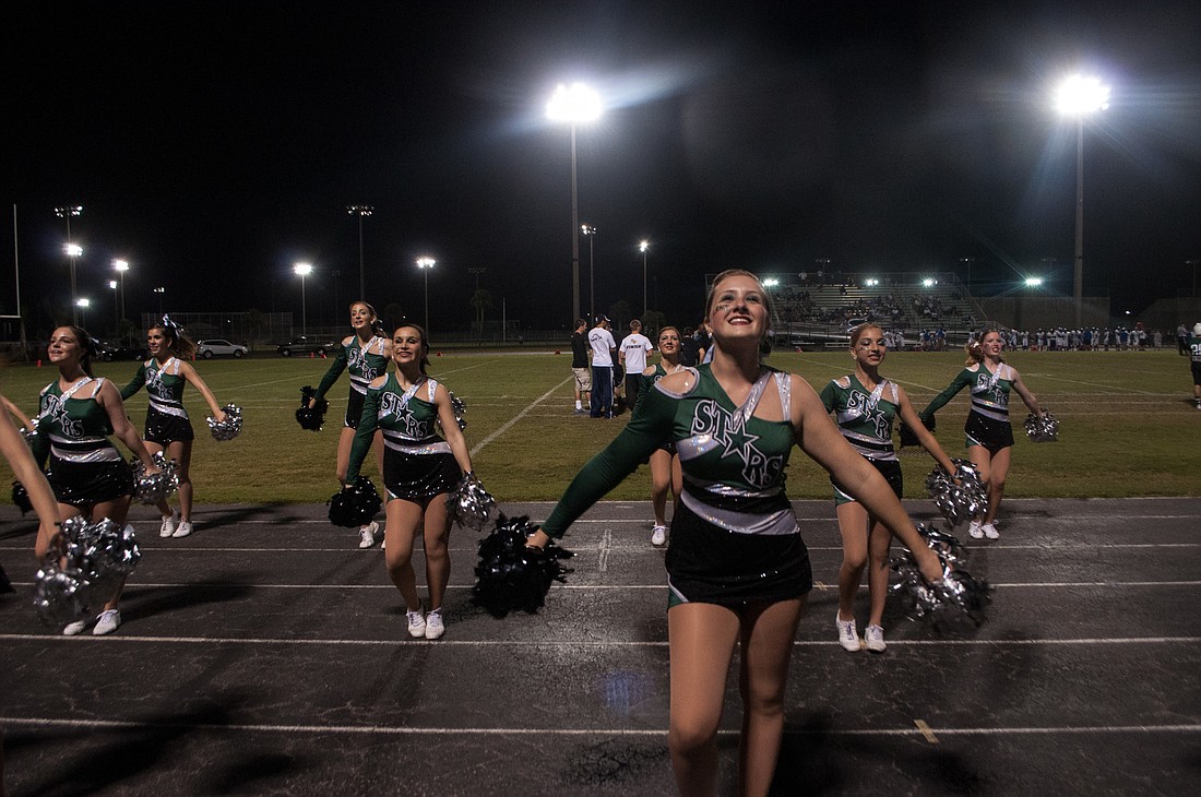 Cheerleaders rouse the crowd at the homecoming game.
