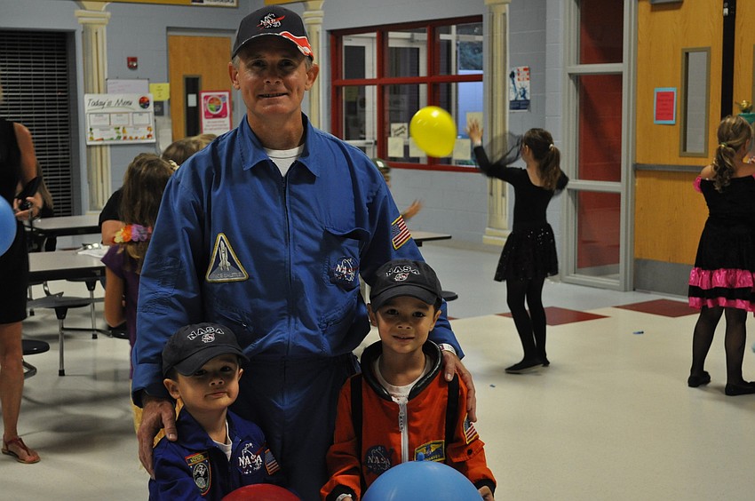 Gary Sandler and his sons Alex and Brandon dressed as astronots and played with balloons at the Freedom Elementary Character Dance.