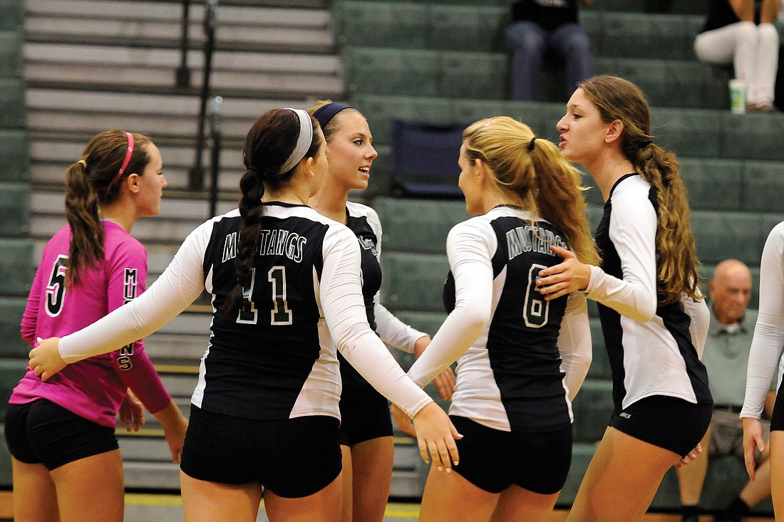 The Lakewood Ranch High volleyball team celebrates a point in its Class 6A-District 12 championship game versus Seminole Osceola Oct. 25. The Lady Mustangs won their second-consecutive district title.