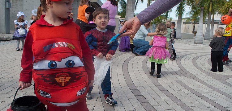 Henry Gilbertson gets a gummy fruit snack from preschool director Sarah Schebel.