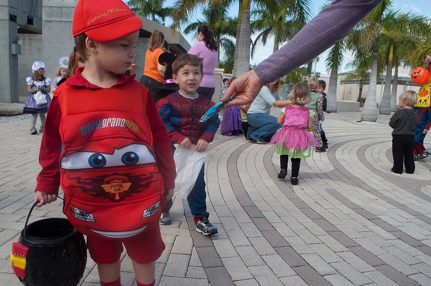 Henry Gilbertson gets a gummy fruit snack from preschool director Sarah Schebel.