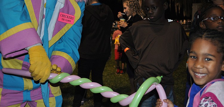 Averi Douglas received a balloon hat from a clown.