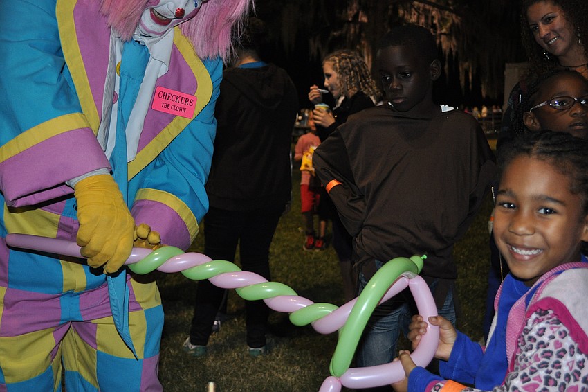 Averi Douglas received a balloon hat from a clown.